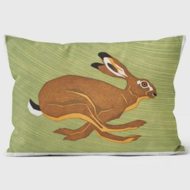 hurry hare in warm browns running facing right against a green background