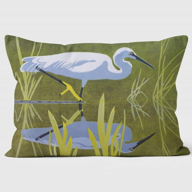 little egret cushion showing the bird stalking facing right in water with green background