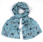 floral scarf with puffins on a blue background tied loosely in a knot