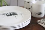 spider plate in foreground with spider mug behind