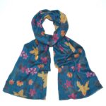 floral scarf with blue background tied loosely in a knot