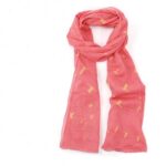 scarf with coral pink background and birds tied loosely in a knot