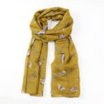 scarf with mustard yellow background and woodpeckers on branches tied loosely in a knot