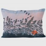 Robert Gillmor - Sunset Flight Cushion by We Love Cushionsshowing birds and grasses silhouetted against an evening sky