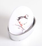 puffin trinket box shows the box with lid ajar, decorated with a drawing of a puffin