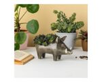 grey plant holder in shape of wild boar with green plants in