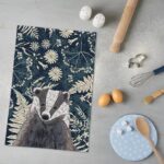 tea towel with badger illustration cooking utensils