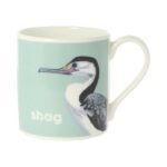 Pale blue mug with black and white bird facing right and text saying shag