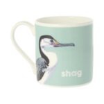 Pale blue mug with black and white bird facing left and text saying shag