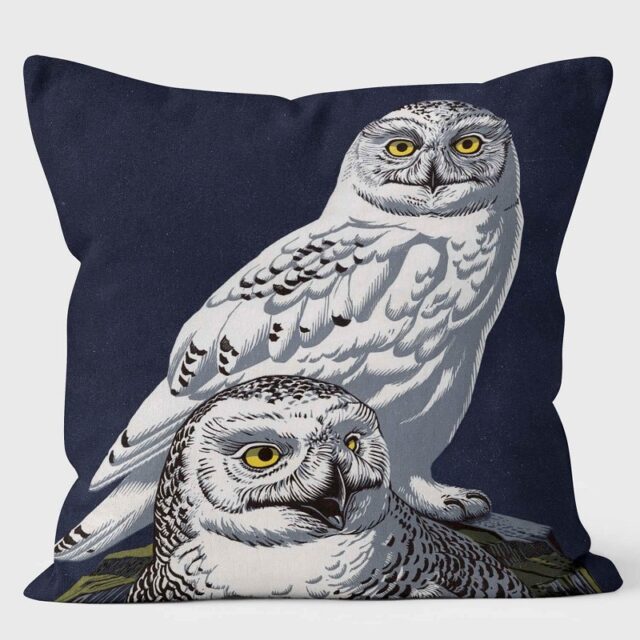 Image of a cushion showing two Snowy Owls against a midnight blue background