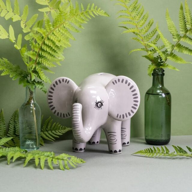 Grey ceramic money box decorated to look like an elephant