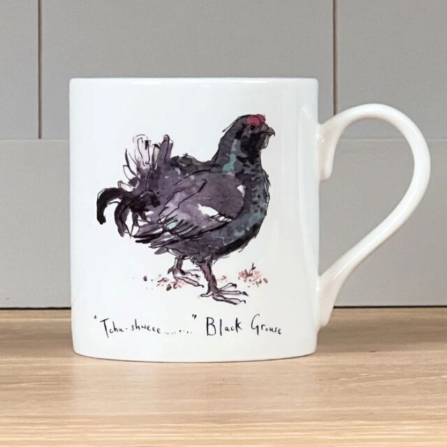 white mug with a black bird on it