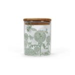 glass storage jar by kate heiss shows a glass jar with sage green decoration of bees and flower heads and a bamboo lid