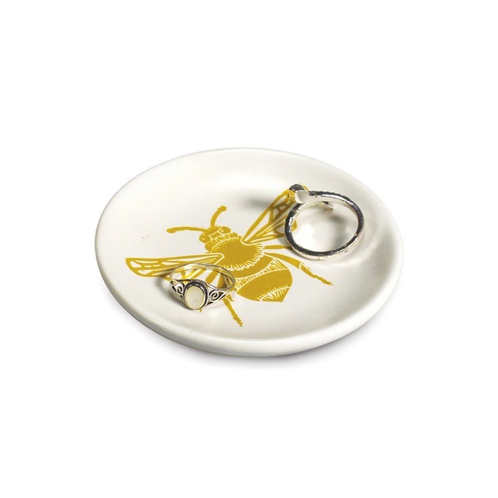 Kate Heiss bee trinket 700 Bee trinket dish by kate heiss showing a small white ceramic dish with a yellow bee design containing rings