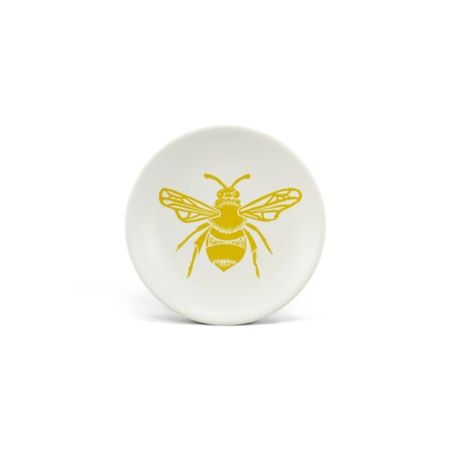 bee trinket dish by kate heiss shows a white ceramic dish with yellow bee design