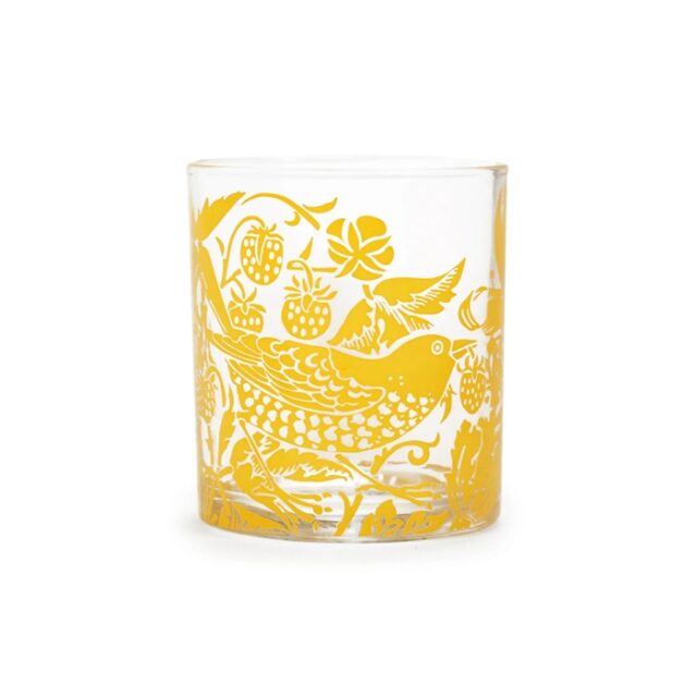 William Morris Glass Tumbler Quince shows a water glass with yellow decoration of a thrush stealing fruit in a garden