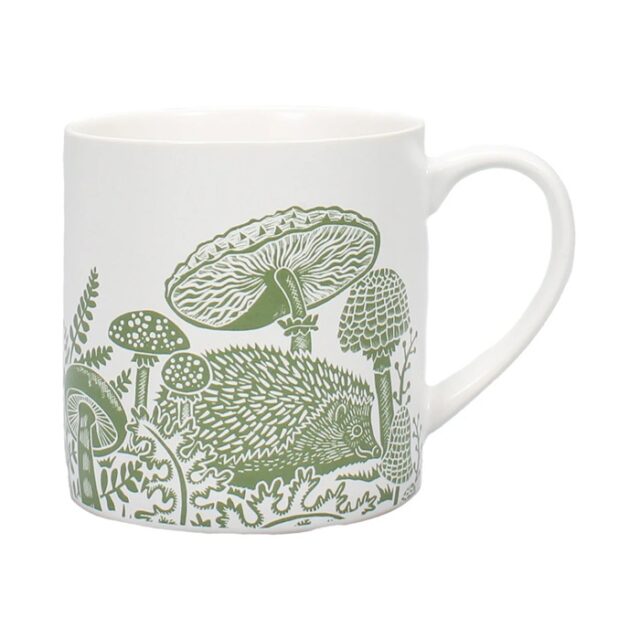 Woodland green mug by kate heiss is a white mug with green illustrations of a hedgehog and funghi