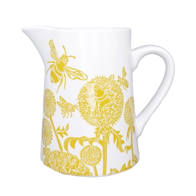 Ceramic jug mustard by kate heiss shows a white jug with yellow illustrations of bees on round allium flower heads