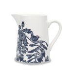 Ceramic jug navy by kate heiss shows a white jug with navy illustrations of a wren on a branch with poppy seed heads, acorns, oak leaves and sycamore seeds