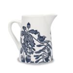 Ceramic jug navy by kate heiss shows a white jug with navy illustrations of a wren on a branch with poppy seed heads, acorns, oak leaves and sycamore seeds