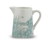 ceramic jug powder blue by kate heiss shows a white jub with pale blue illustration showing poppies and grasses growing on the beach with the sea and a seabird behind