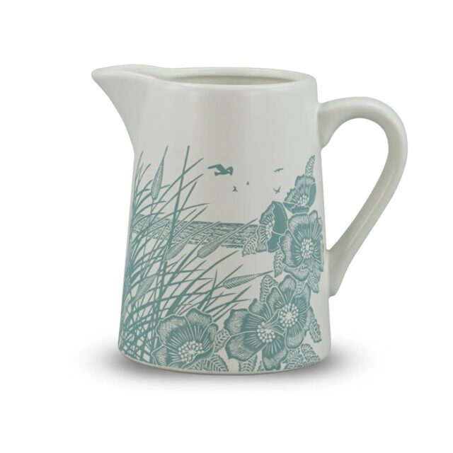 ceramic jug powder blue by kate heiss shows a white jub with pale blue illustration showing poppies and grasses growing on the beach with the sea and a seabird behind