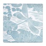 Ceramic Coasters Powder Blue by Kate Heiss shows a square blue and white ceramic coaster with illustrations of dragonflies