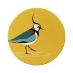 Shows a round yellow coaster with an illustration of a lapwing, part of the RSPB Ceramic Water Birds Coasters set