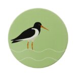 Shows a round green coaster with an illustration of an oystercatcher, part of the RSPB Ceramic Water Birds Coasters set