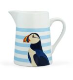 RSPB puffin jug shows a white jub with horizontal light blue stripes and a puffin's head and body in blue black and white with a colourful beak