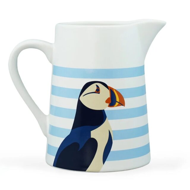 RSPB puffin jug shows a white jub with horizontal light blue stripes and a puffin's head and body in blue black and white with a colourful beak