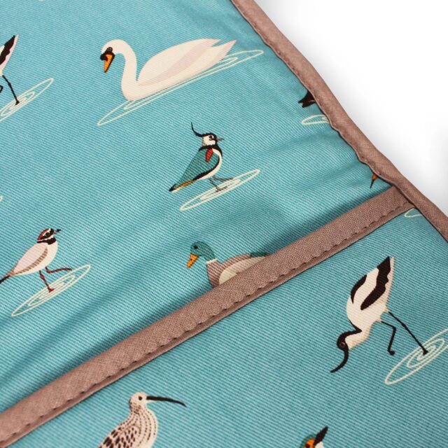 RSPB water birds double oven glove shows the detail of the fabric which is decoated with avocets, swans, plovers, lapwings and curlew