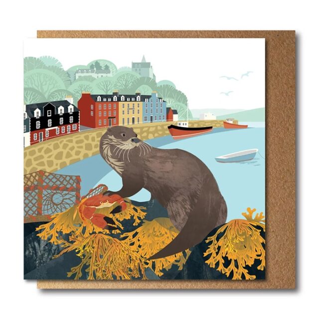 Otter Greetings Card by Rachel Hudson shows a large otter no a cliff top overlooking the sea shore with buildings in the background