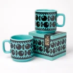 Hornsea Fish Mug in Teal by Magpie shows two mugs and the gift box it comes in