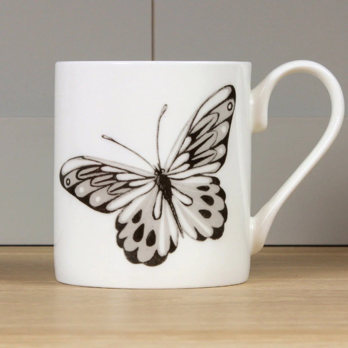 Brown Butterfly Mug by Holly Lasseter image shows a sepia brown illustration of a butterfly on a white mug