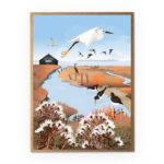Little Egret and Boat House Greetings Card by Rachel Hudson shows a white bird in flight with long legs trailing behind above an inlet with a black boat house to the left and black and white birds in the foreground