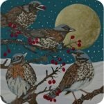 Fieldfares Winter Visitor Placemat by Sue Welfare shows four grey headed birds with reddish specked breasts and brown wings sitting on twigs with red berries, a snowy landscape and a full moon behind