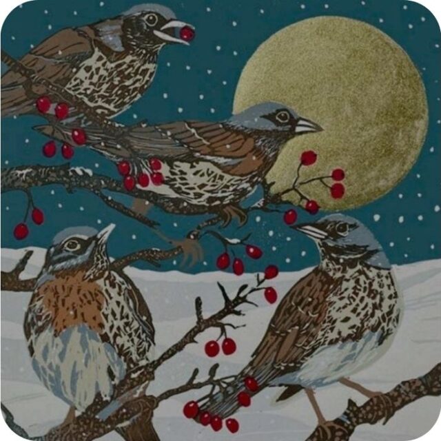 Fieldfares Winter Visitor Placemat by Sue Welfare shows four grey headed birds with reddish specked breasts and brown wings sitting on twigs with red berries, a snowy landscape and a full moon behind