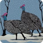 Guinea Fowl Winter Walk Placemat by Sue Welfare shows two birds with black and white speckled wings and bodies, and blue heads with pink crests walking across a snowy landscape with dark silhouettes of trees and a blue snowy background