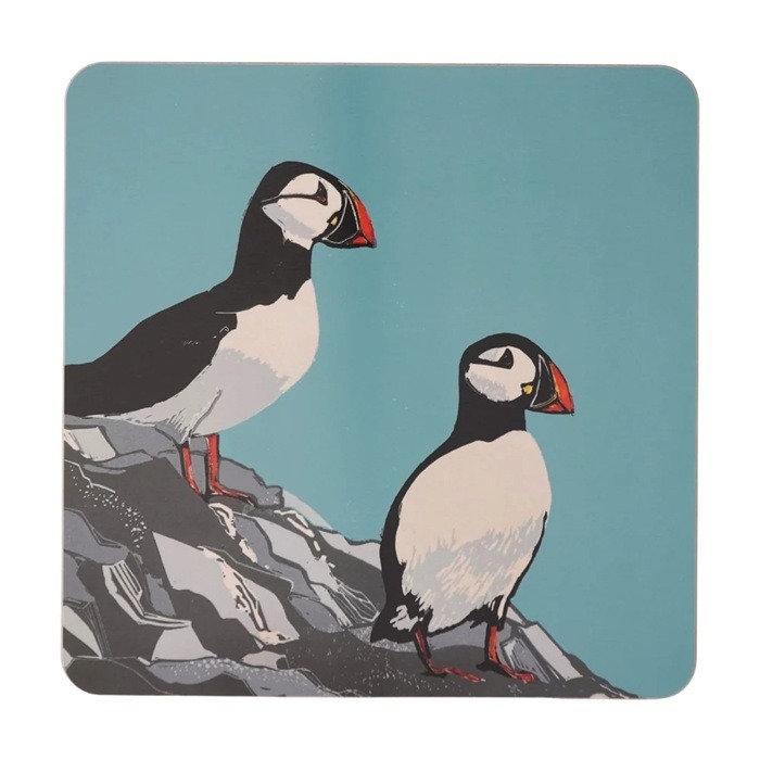 Puffins Placemat by Sue Welfare shows two black and white birds with colourful bills standing on the edge of a cliff against a blue background