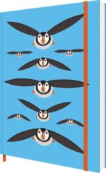 i like birds notebook shows black stylised puffins flying against a blue background. A red elastic ribbon runs top to bottom around the book